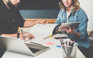 Two people at a desk working